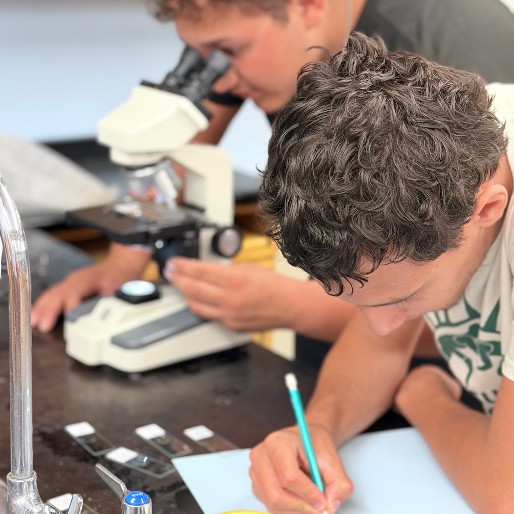 Student looking at a microscope