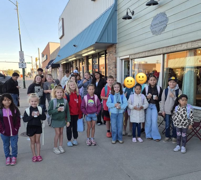 Students gather in front of a local coffee shop.