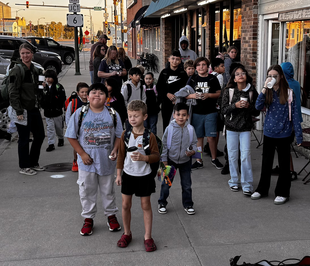 Students gather in front of a local coffee shop.