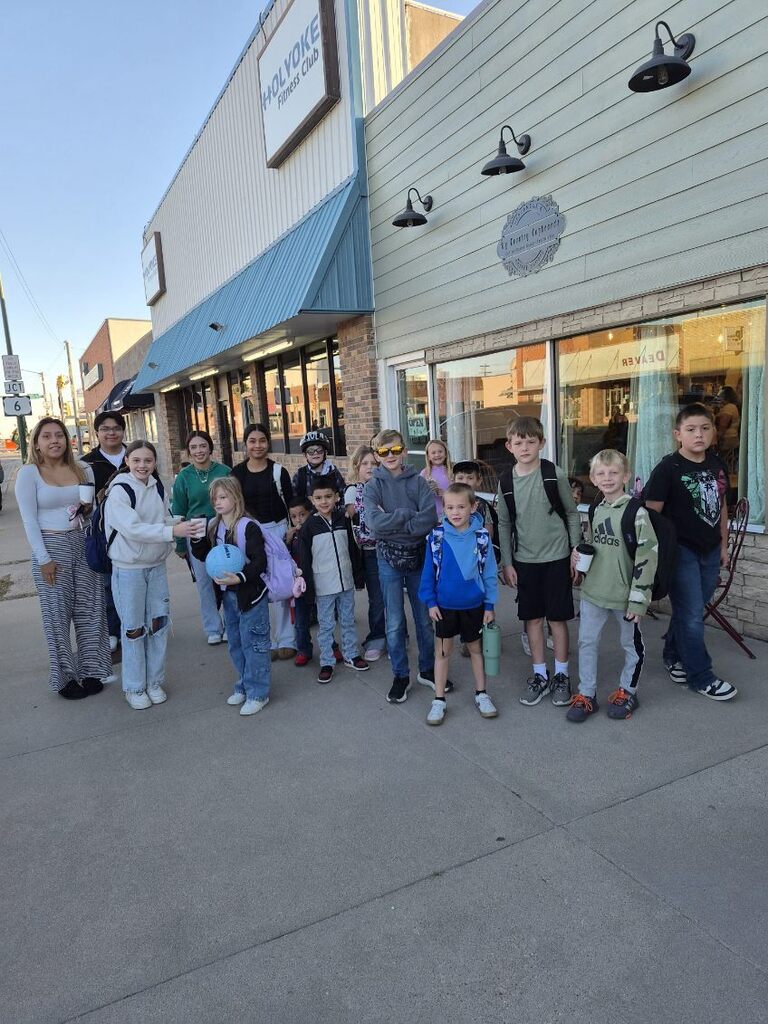 Students gather in front of a local coffee shop.
