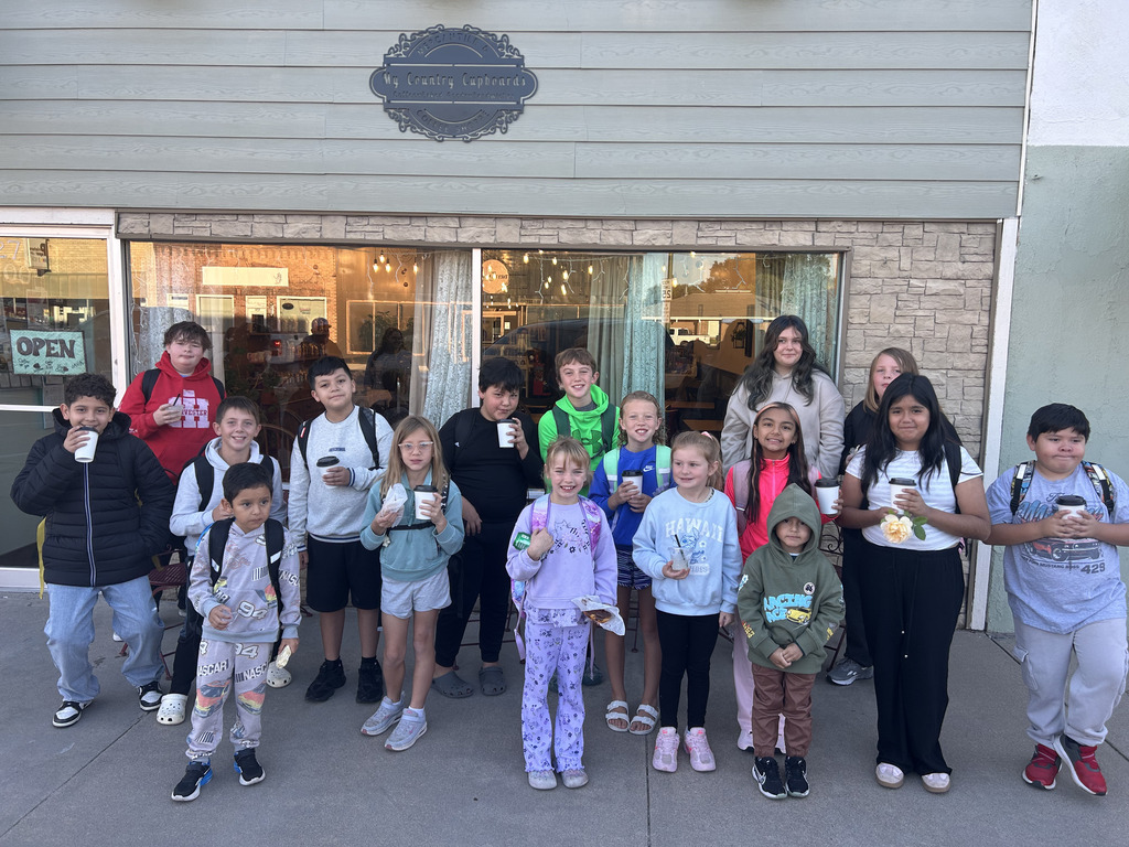 Students gather in front of a local coffee shop.