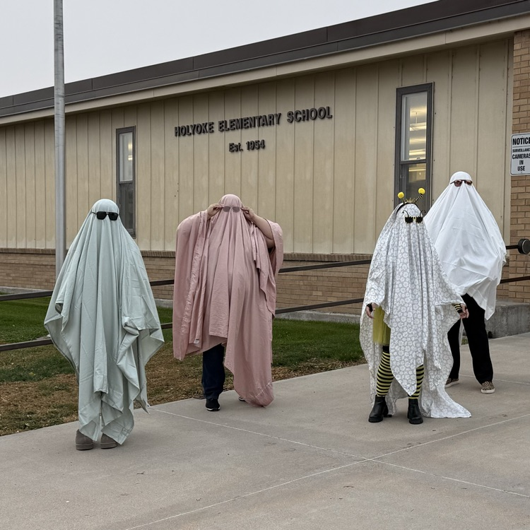 ladies dressed as ghosts greeted students