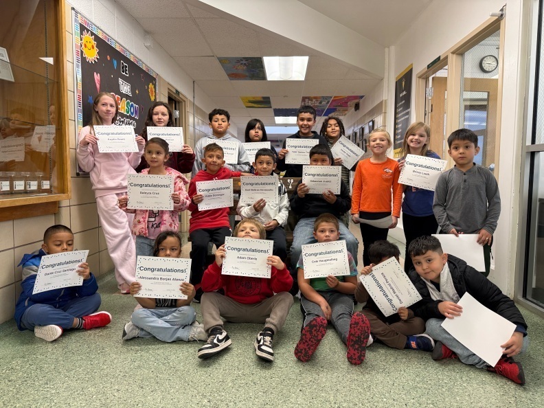 Students holding a certificate
