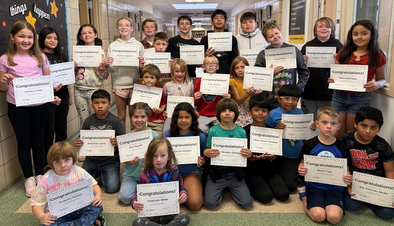 Students holding a certificate