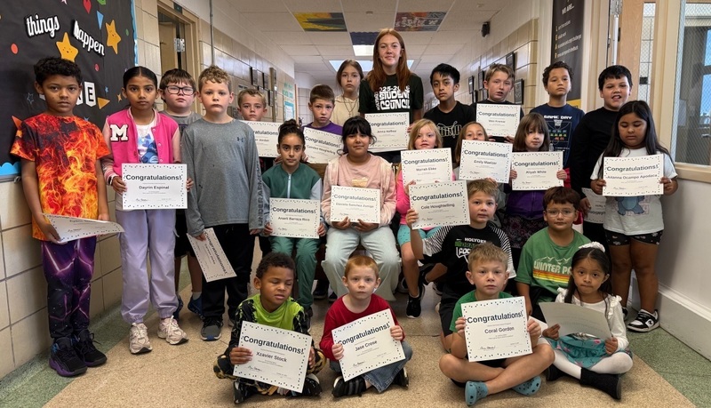 students holding a certificate