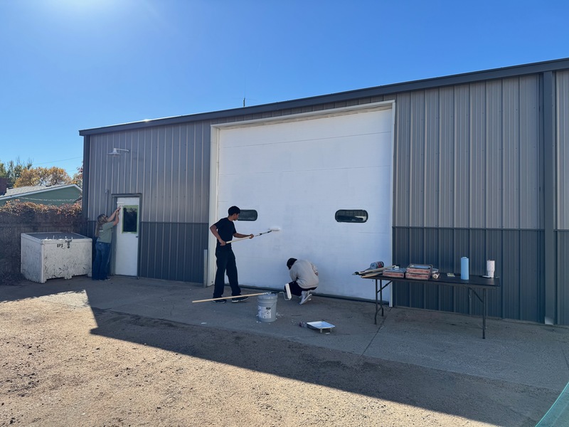 People painting a garage door
