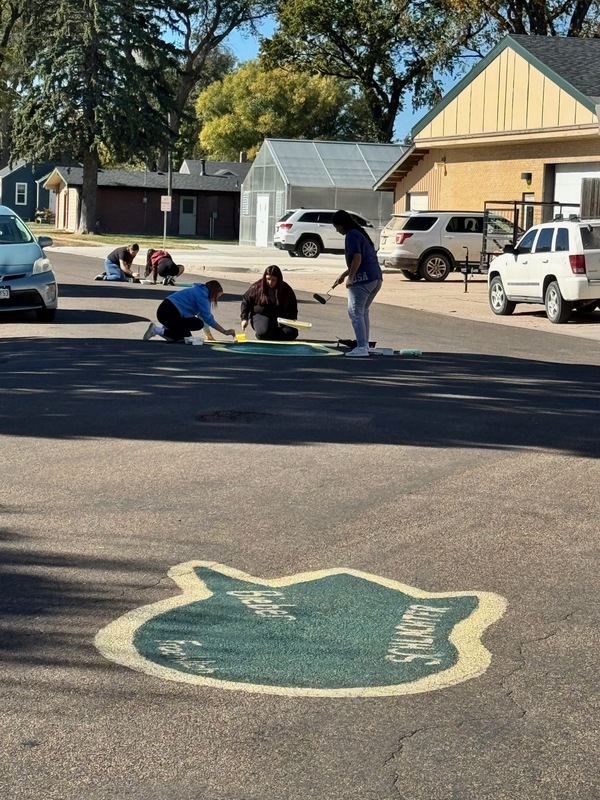 students painting dragon prints on the street