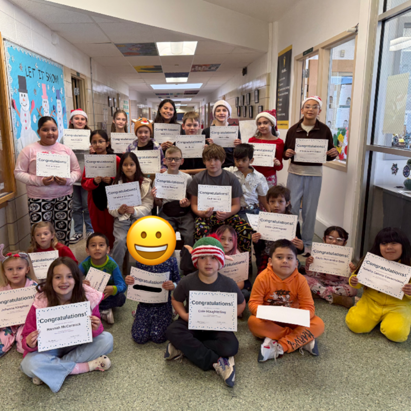 students in pajamas holding certificcates