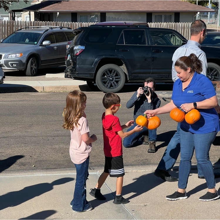 students with a pumpkin