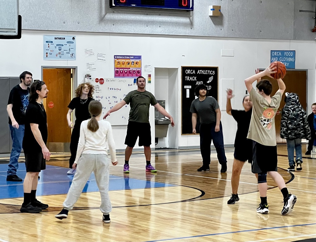 students and staff playing basketball