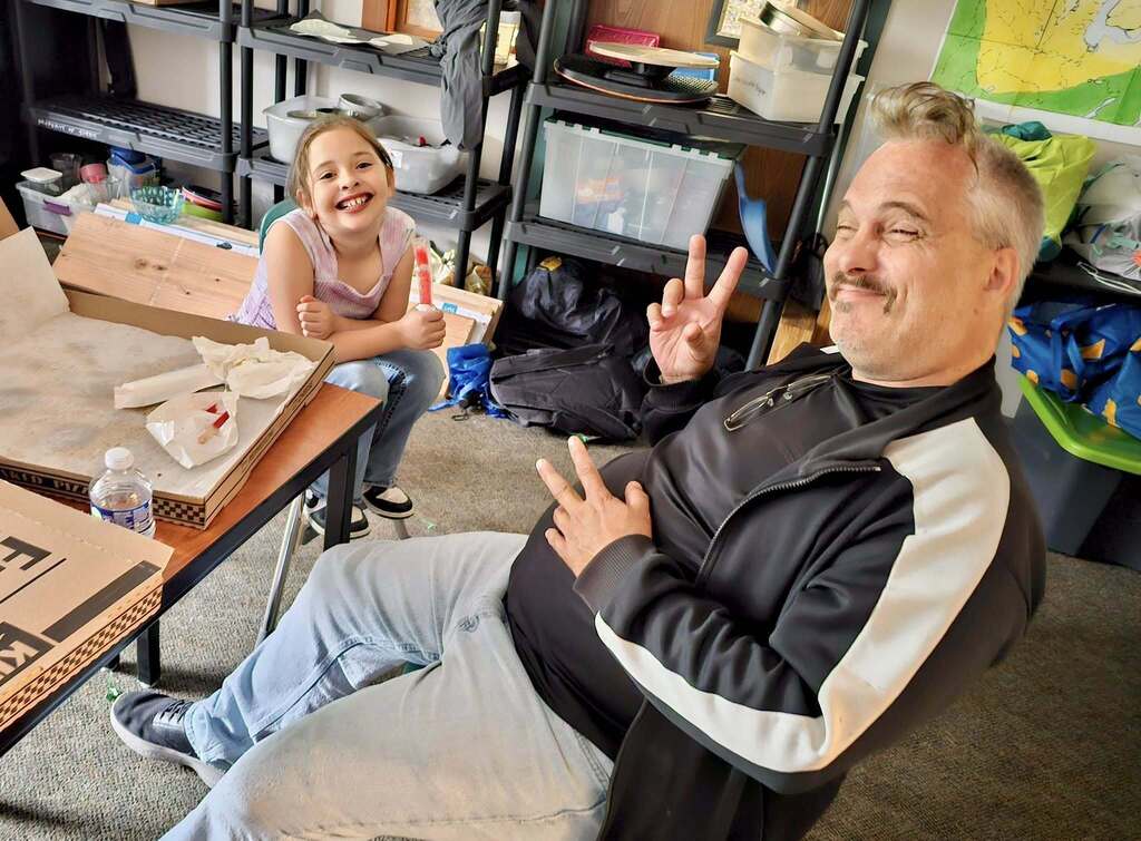 Bus Driver Brian hanging out with students thanking them for being outstanding bus helpers!