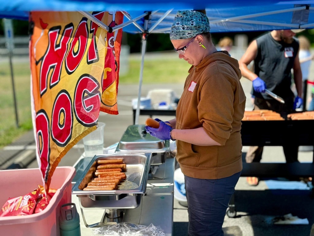 Serving hot dogs outside at field day.