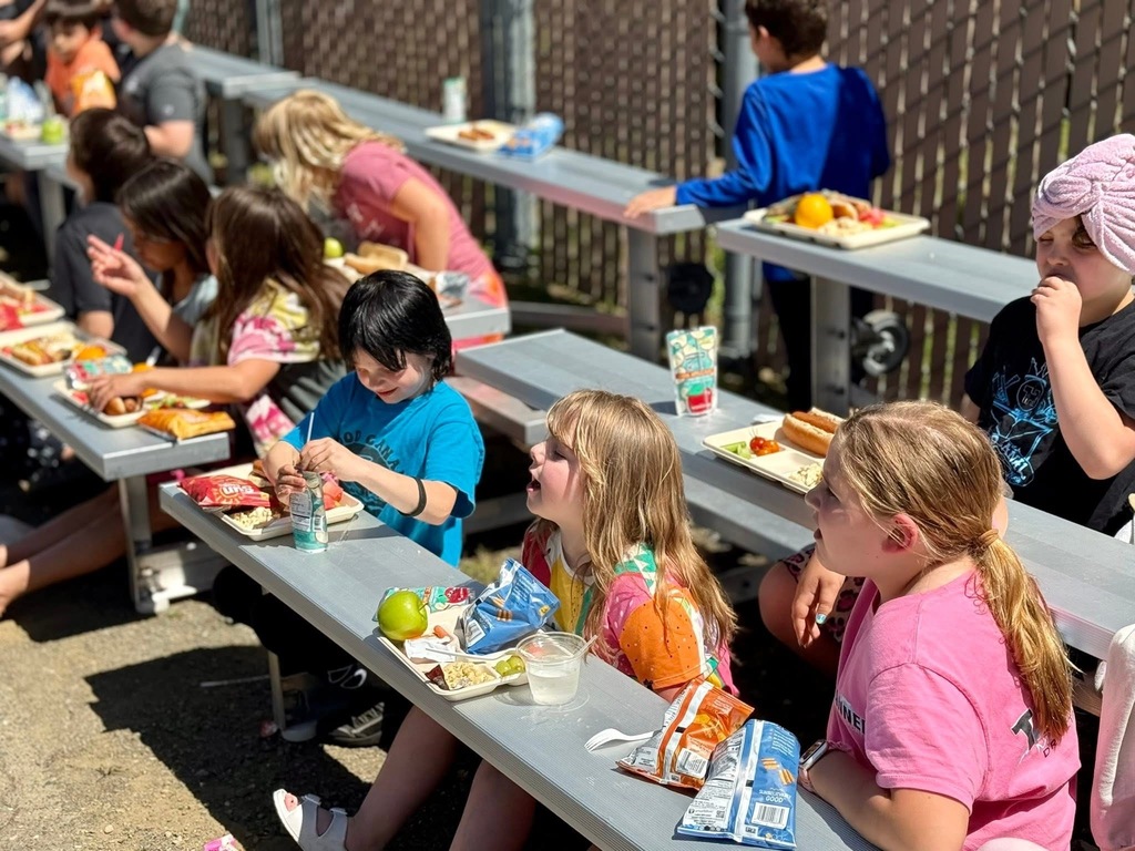 Student enjoying their lunches outside.