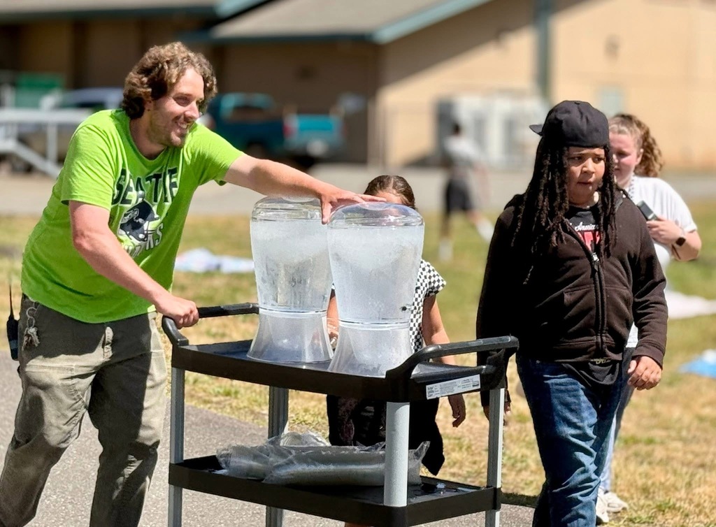 Joe Stanley bringing water out for every one for lunch and field day.