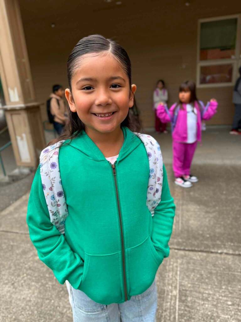 Student 1 all ready for school in her green jacket and backpack!