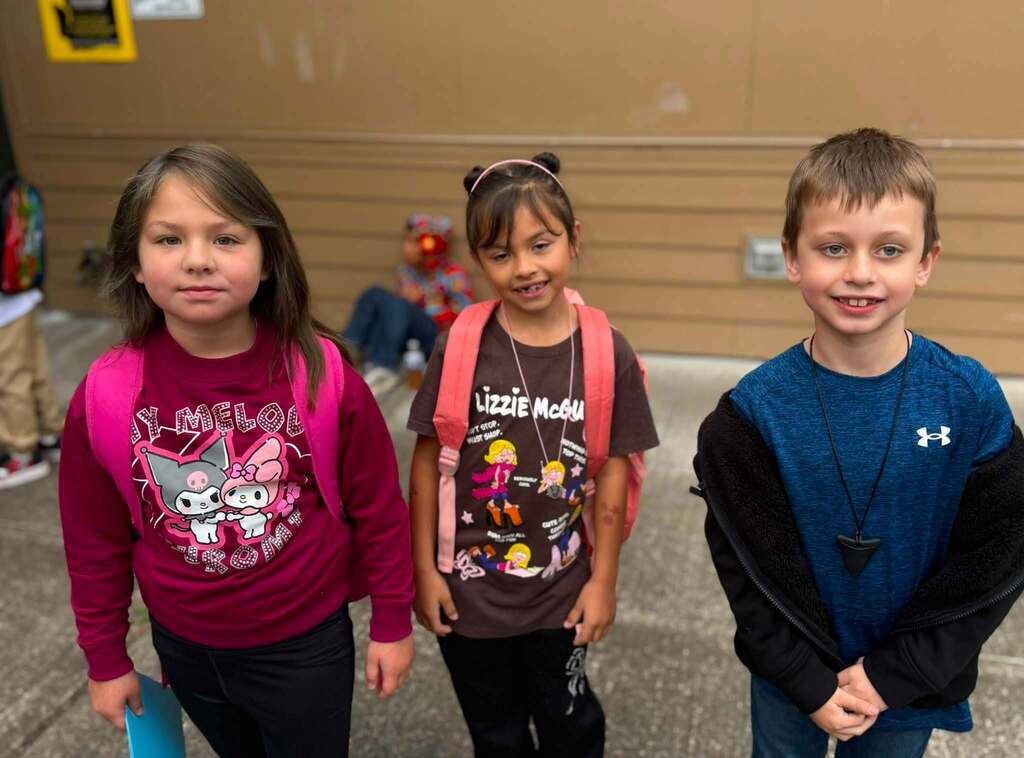 Excited to be with friends. These three students are happy to be back at school.