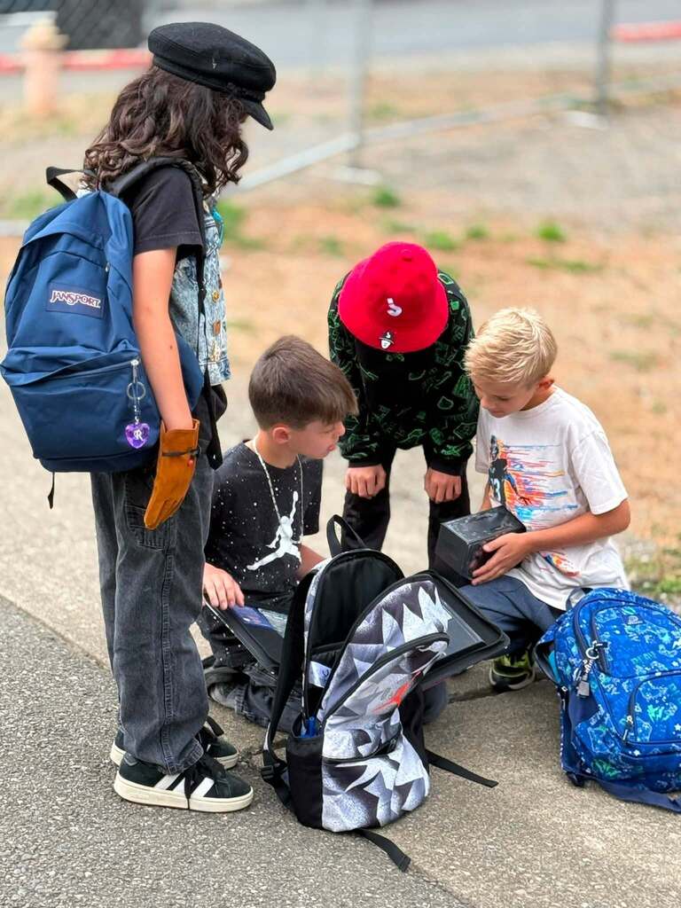 Four students saying hi to each other and catching up on the first day of school.