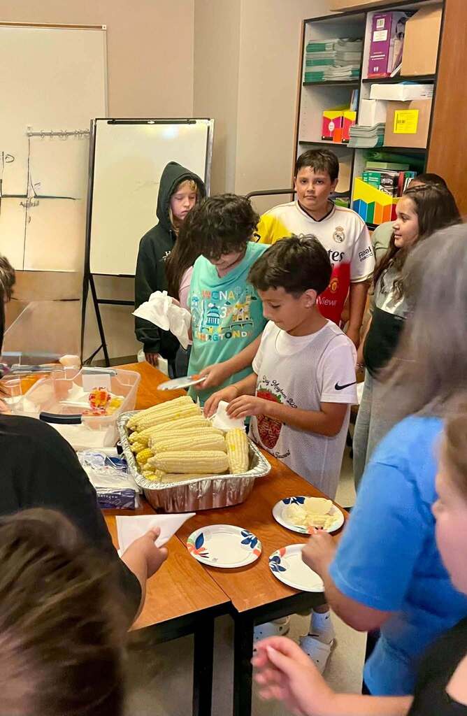 5th Graders preparing the corn to enjoy.