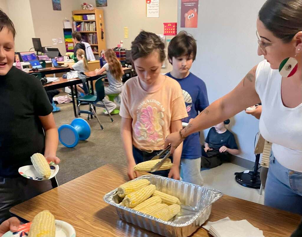 Mariah serving the the corn to our 5th graders.