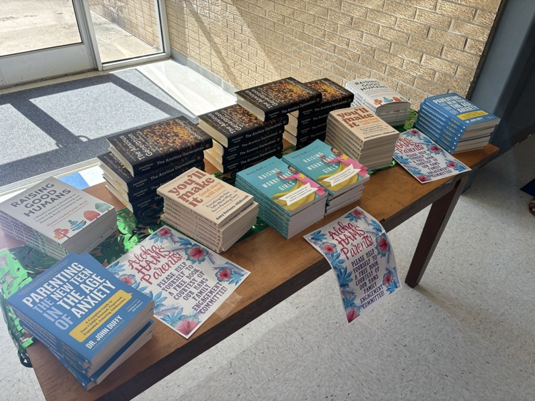 HAMS family engagement committee gave out books to parents to assist in raising middle school aged students during the open house  