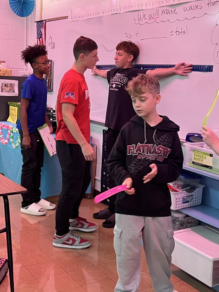 5th hour boys measuring their wingspans 