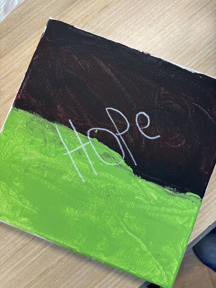 Green and black canvas with the word “hope."
