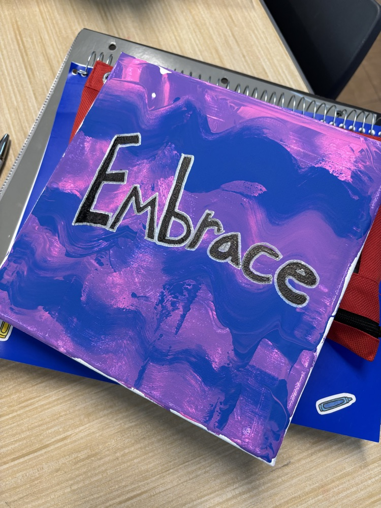 pink and purple canvas with the word “embrace"