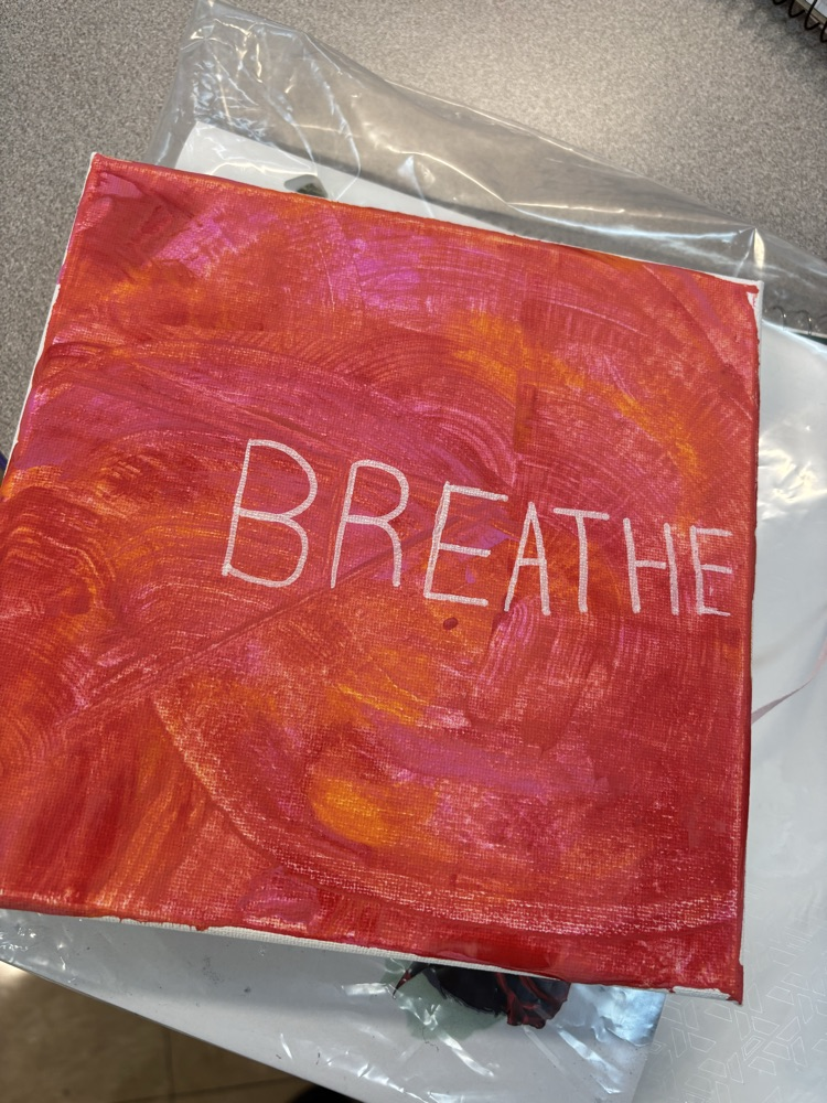 yellow and orange canvas with the word “breathe"
