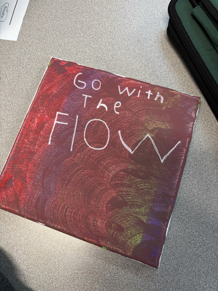 red and green canvas with the words “go with the flow” 