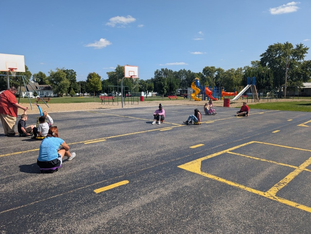 Mrs. Huffman's PE class working on core strength and conditioning with scooters.