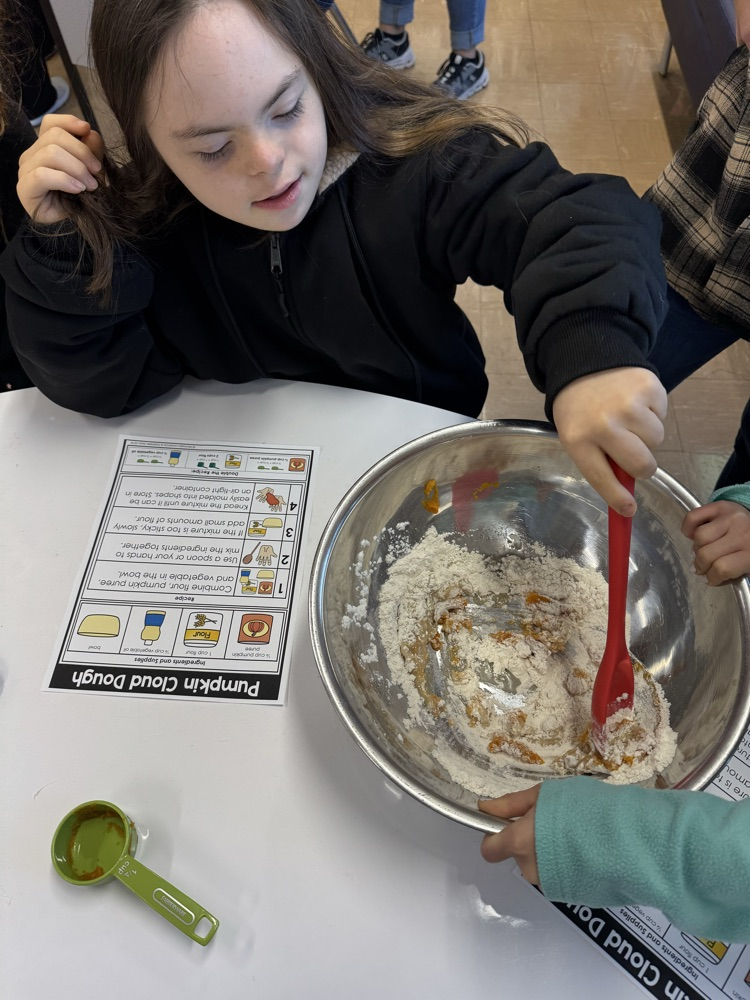 student mixing with a red spoon