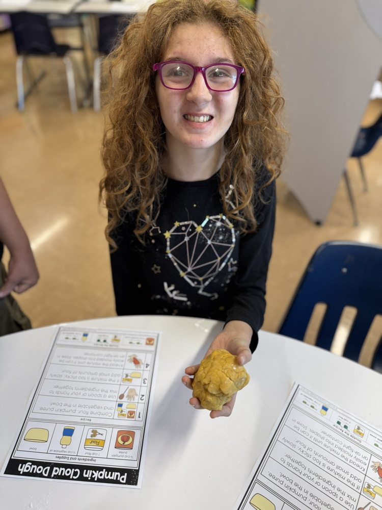 student holding cloud dough