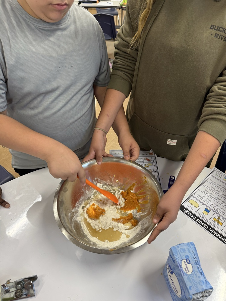 two students mixing cloud dough