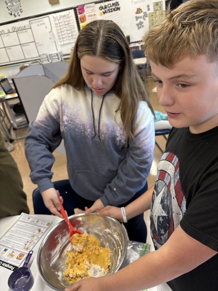 two students mixing cloud dough