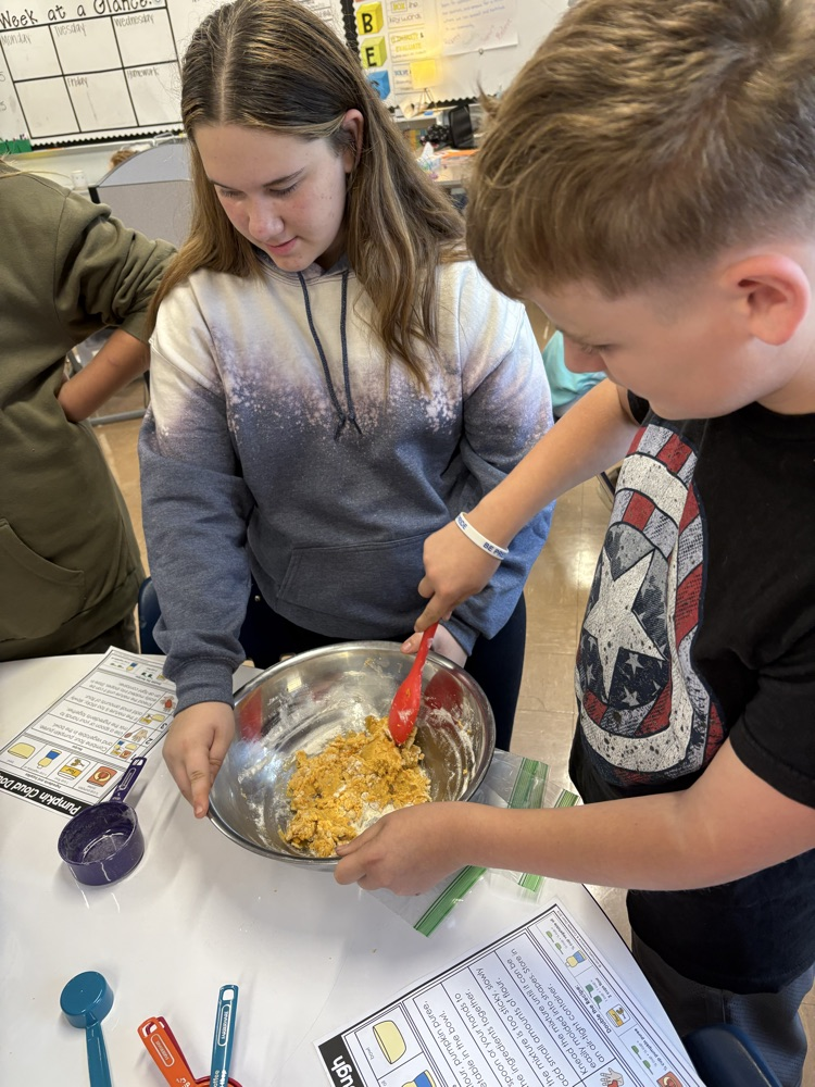 two students mixing cloud dough