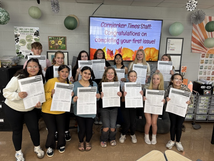 students holding newspapers