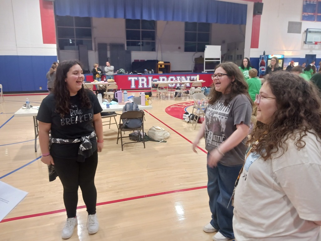 Three students practicing in an open gym before the performance.