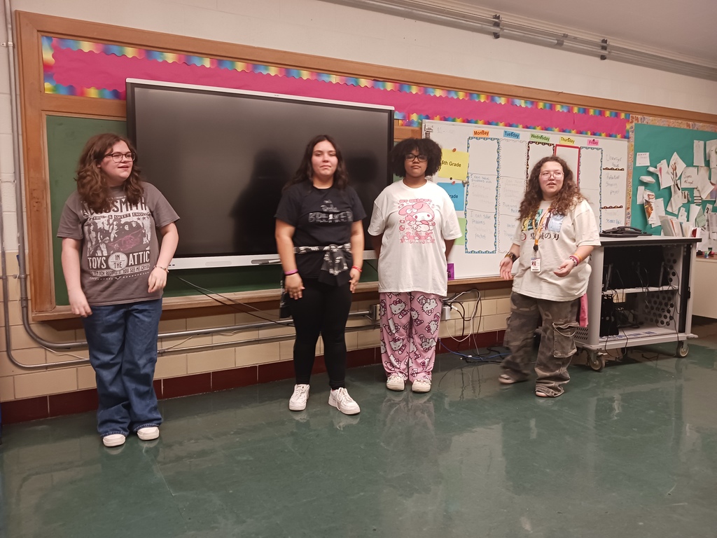 Four students acting out a group scene.
