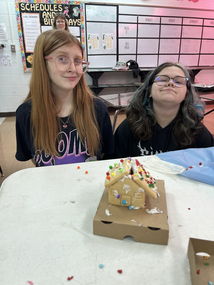 female students with their gingerbread house 
