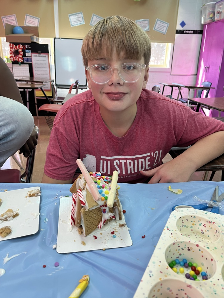 male student with his crooked gingerbread house 