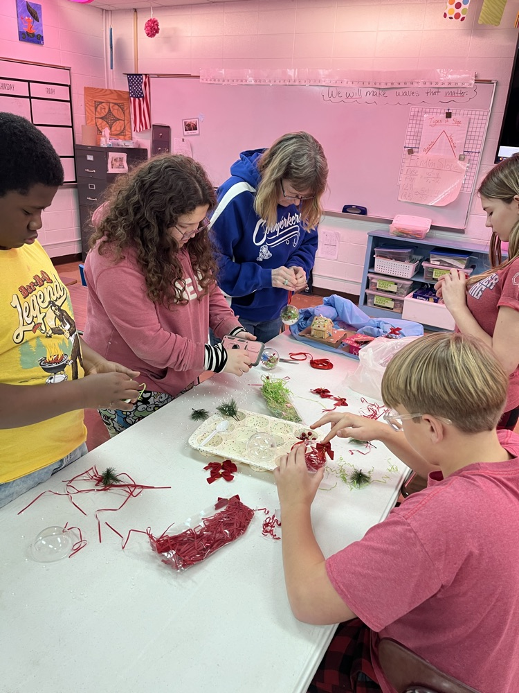 group of students making ball ornaments 