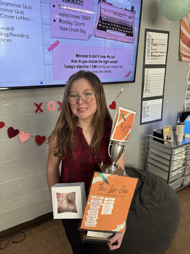 8th grade award winner holding trophy