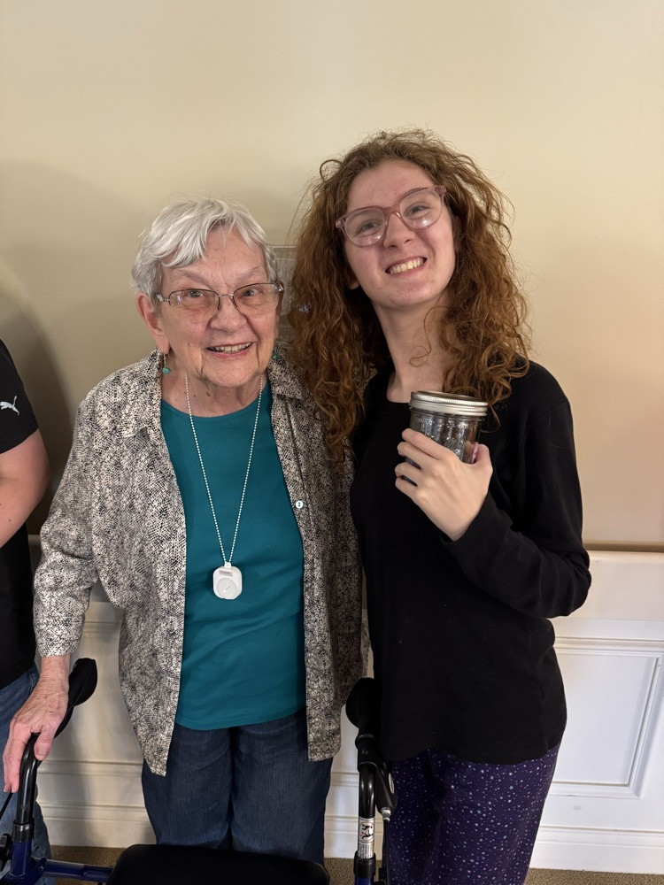 a red headed girl posing with an older lady 