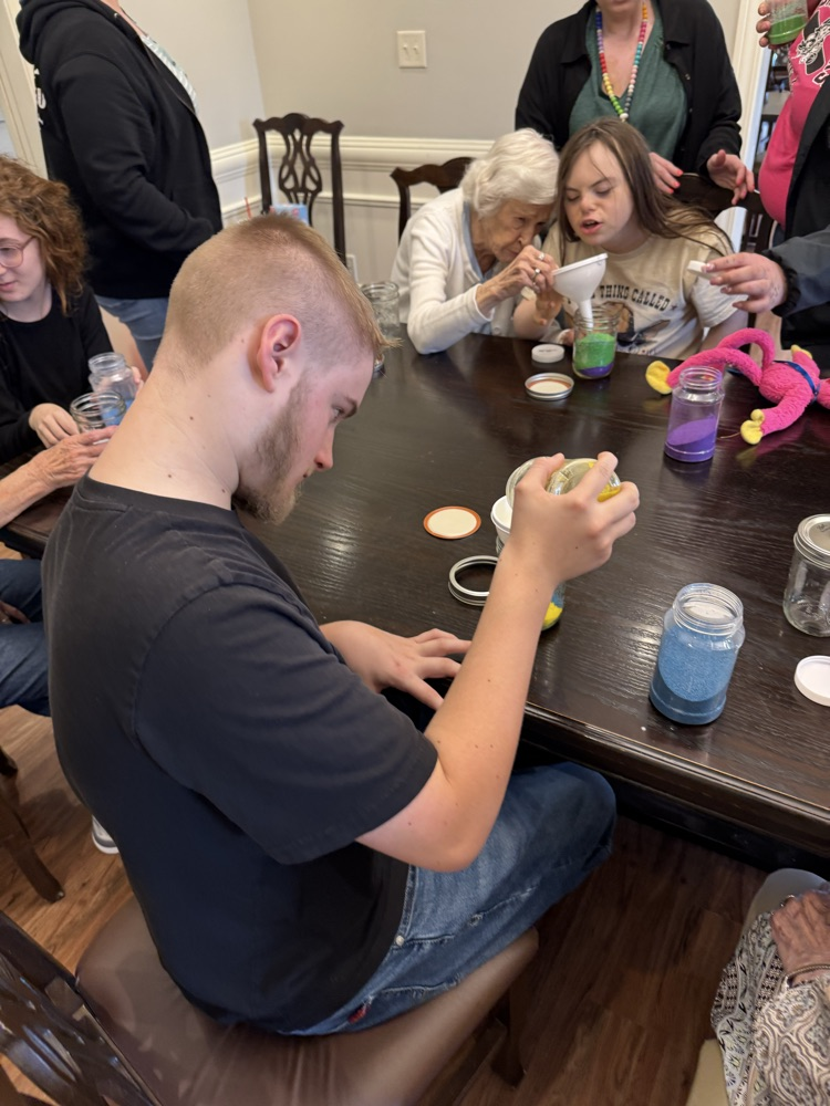 student making craft with sand 