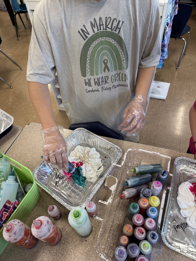 a student putting tie dye together 