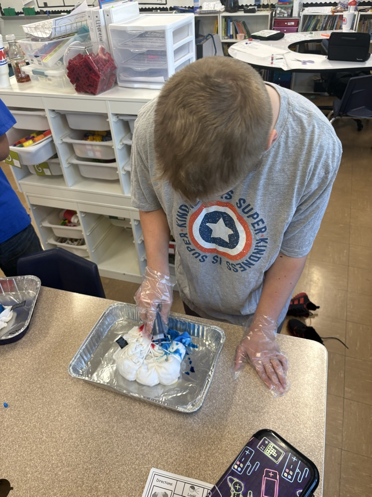 one male student tie dying a shirt 