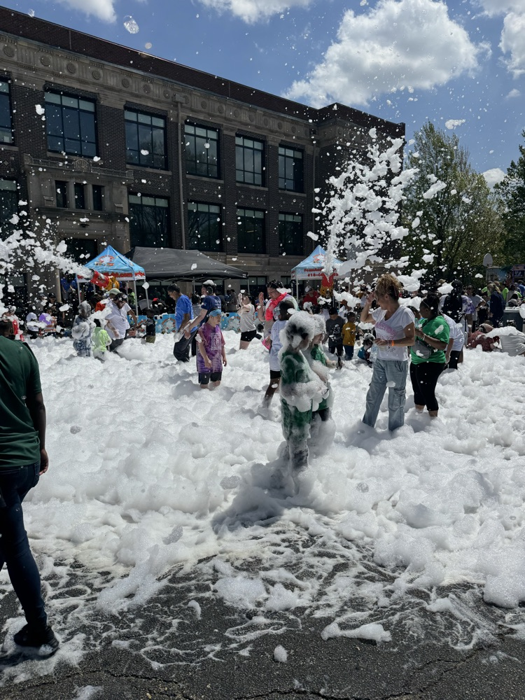 students playing in foam outside 