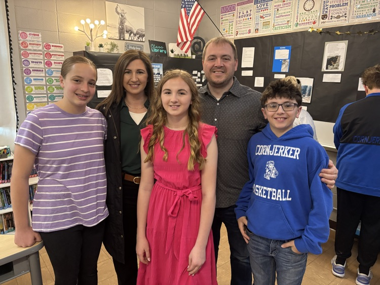 Smiling family with students 