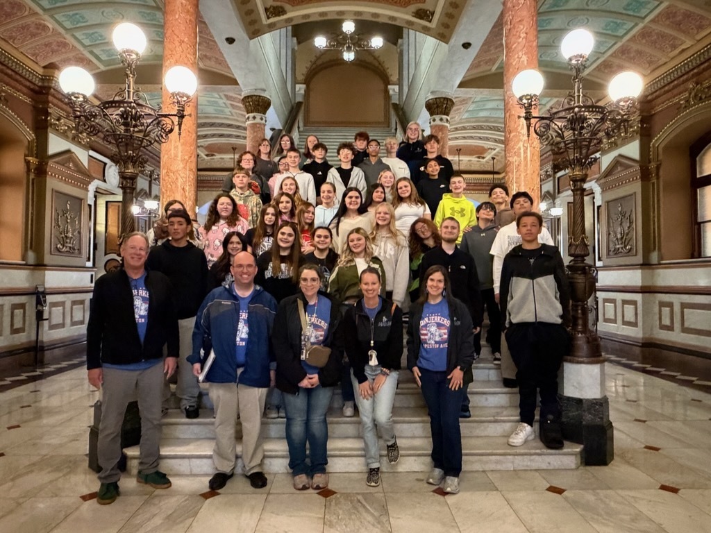 Students and chaperones standing on a staircase inside the Illinois State Capitol. 