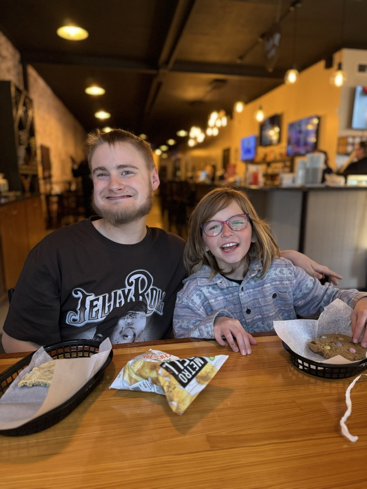 two students in a coffee shop with cookies